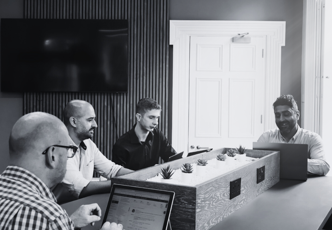 A group of people sitting around a table working